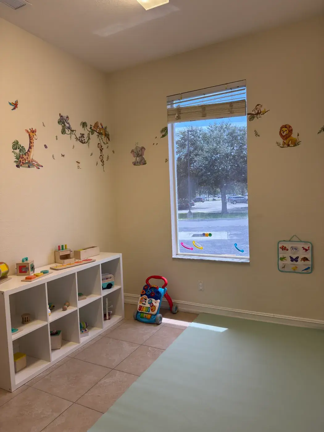 The infant and toddler room with open shelving and a floor mat at Ellie's World PPEC in Port Charlotte, Florida
