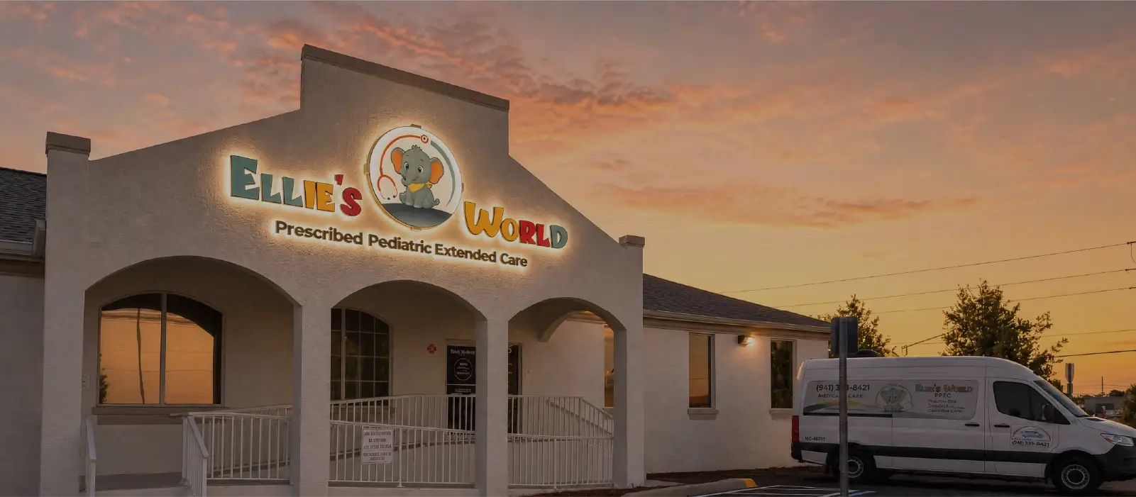 The illuminated building sign at sunset at Ellie's World PPEC in Port Charlotte, Florida