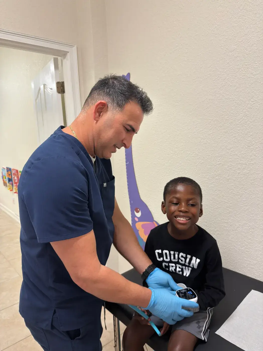 A nurse taking a school-age boy's vital signs after school at Ellie's World PPEC in Port Charlotte, Florida
